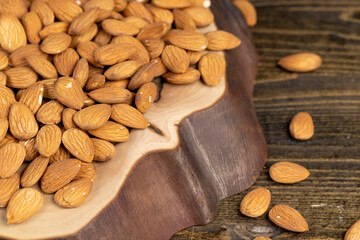 ready-to-eat almond nuts on a wooden table, closeup