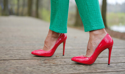 women's feet in red stiletto heels