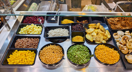 A salad bar featuring an extensive variety of fresh vegetables and fruits