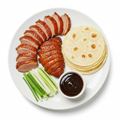 Thinly sliced peking duck with crispy skin, cucumber, scallions and hoisin sauce with pancakes, white plate isolated on white