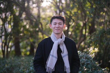 smiling Asian young looking at camera, outdoor in winter
