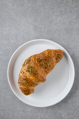pistachio croissant on white plate