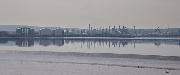 Panoramic view of the chemical and industrial works on the south side of the Forth Estuary viewed across the Forth at low tide, Scotland, UK.