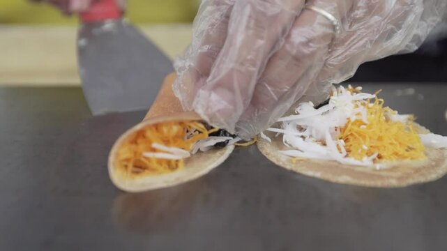A local vendor makes traditional Thai crispy crepes called Khanom Buang, an ancient snack since the Ayutthaya era that comes in both sweet and savory varieties.