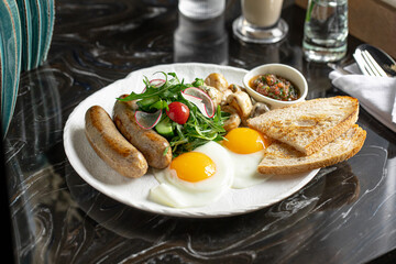 Portion of breakfast with sausages and fried eggs