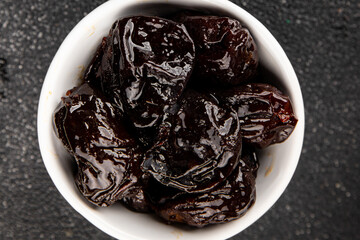 Prunes dried fruit smoked plum snack fresh delicious gourmet food background on the table rustic food top view copy space keto and paleo diet vegetarian and vegan food