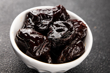 Prunes dried fruit smoked plum snack fresh delicious gourmet food background on the table rustic food top view copy space keto and paleo diet vegetarian and vegan food