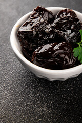 Prunes dried fruit smoked plum snack fresh delicious gourmet food background on the table rustic food top view copy space keto and paleo diet vegetarian and vegan food