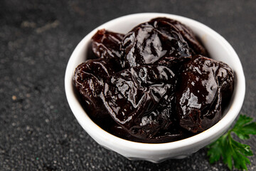 Prunes dried fruit smoked plum snack fresh delicious gourmet food background on the table rustic food top view copy space keto and paleo diet vegetarian and vegan food