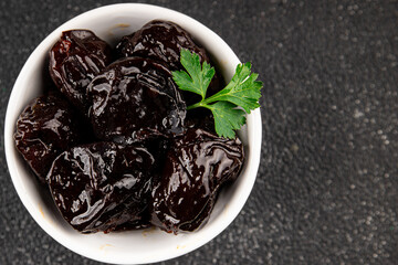 Prunes dried fruit smoked plum snack fresh delicious gourmet food background on the table rustic food top view copy space keto and paleo diet vegetarian and vegan food