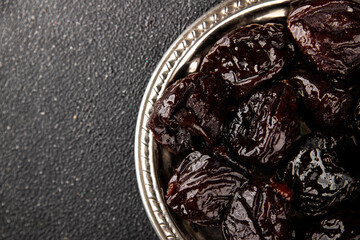 Prunes dried fruit smoked plum snack fresh delicious gourmet food background on the table rustic food top view copy space keto and paleo diet vegetarian and vegan food