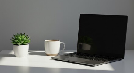 Fototapeta premium Laptop computer workspace with coffee mug and plant
