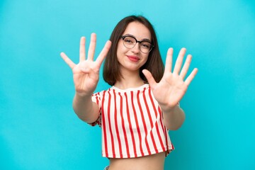 Young Ukrainian woman isolated on blue background counting nine with fingers