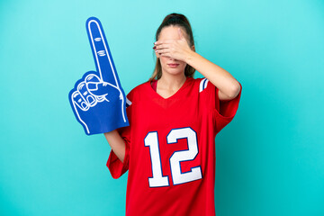 Young caucasian sport woman isolated on blue background covering eyes by hands. Do not want to see...