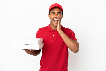 African American pizza delivery man picking up pizza boxes over isolated white wall shouting with...