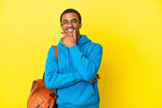 African American student man over isolated yellow background smiling