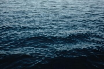 Obraz premium Dark Blue Ocean Water With Gentle Waves Abstract Background And Ripples on the Surface With Turquoise Color