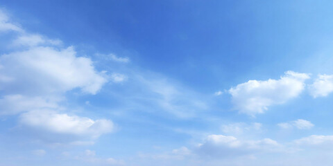 Fototapeta premium tranquil summer sky with soft, fluffy clouds scattered across bright blue background, evoking sense of peace and serenity