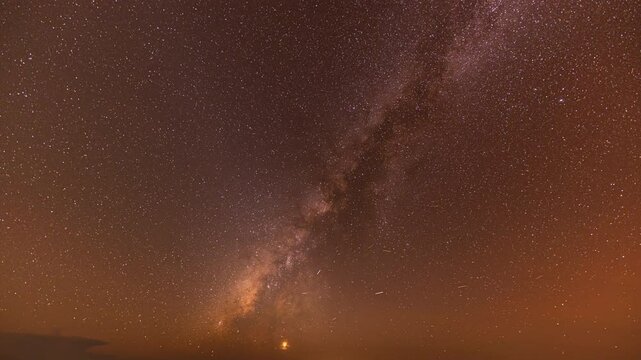 The Milky Way is bright and clear in the dark sky on Doi Chik Chong in Mae Hong Son Thailand. It is a remote place with beautiful nature and fresh air.The Milky Way orbits over a steep mountain range