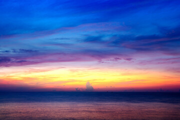 Fototapeta premium Aerial view sunset sky, Beautiful Light Sunset or sunrise over sea,Colorful dramatic majestic scenery sunset Sky, Amazing clouds and small waves in the ocean, Wonderful light cloud background