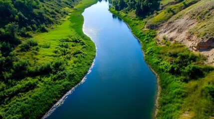A river with green grass and trees on both sides