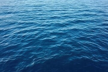 Obraz premium Vibrant Blue Ocean Water Texture with Ripple Pattern in Sunlight Creates a Dynamic Seascape Ideal for Backgrounds