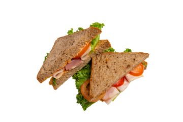 Two ham sandwiches with lettuce, tomato, and ham on whole-wheat bread are isolated on a white background.