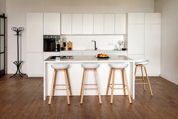 Modern white kitchen with island and wooden stools