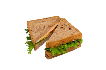 Two ham sandwiches with lettuce, tomato, and ham on whole-wheat bread are isolated on a white background.