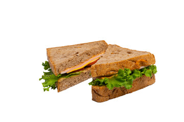 Two ham sandwiches with lettuce, tomato, and ham on whole-wheat bread are isolated on a white background.