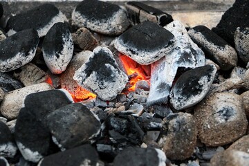 close-up of glowing charcoal on the grill