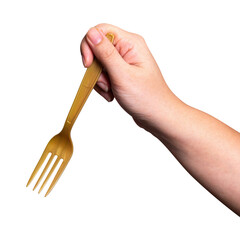 Female hand holding a gold plastic fork isolated on white background.
