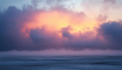 Obraz premium Ethereal Sunset Landscape with Clouds and Hazy Horizon in Shades of Blue Purple and Orange Reflecting Light Across Open Terrain Offering a Sense of Tranquility and Natural Beauty