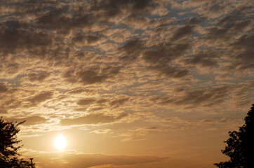 Sun and cloudy sky at sunset in spring