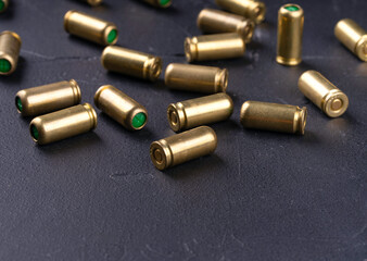 Scattered 9mm blank patnons on dark background