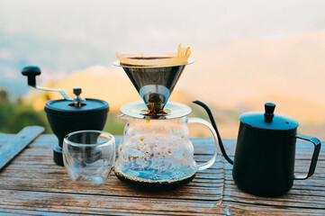 Drip coffee with mountains view,  drip coffee kit set with mountain in sunrise background..