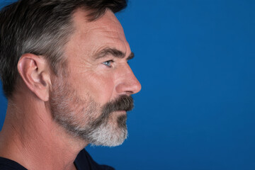 Obraz premium navigator portrait on bright ultramarine background focused expression face positioned on right side of frame