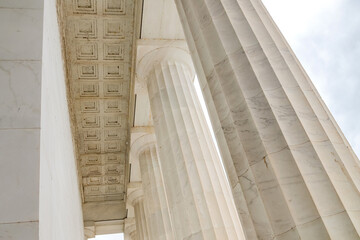 Fragment of the building with elegant white columns. View from below. © kosoff