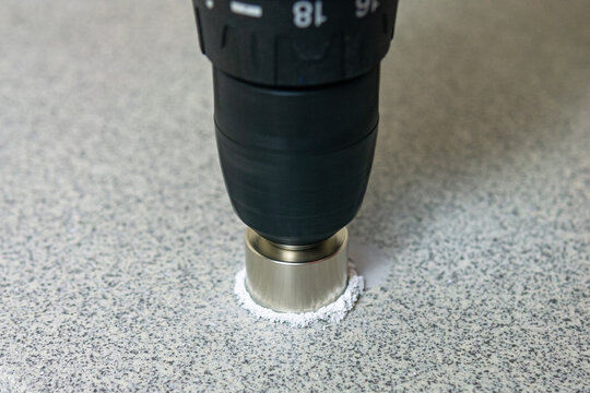 rotating diamond-coated hole saw in drill drills stone slab