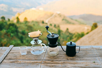 Drip coffee with mountains view,  drip coffee kit set with mountain in sunrise background..
