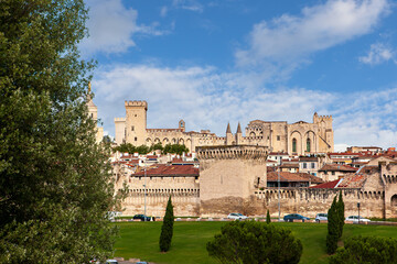 Papal Palace stands majestically in Avignon, showcasing historical architecture under a clear blue sky. Avignon, France. UNESCO World Heritage Site