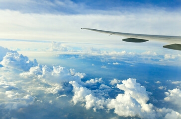 Airplane Wing in flight from window, Clouds and sky
