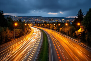 Highway light streaks lead to the illuminated cityscape, under a cloudy evening sky