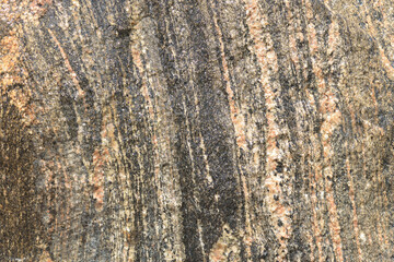 water glistening down over granite rock with variegated coloration