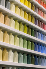 Many small jars of the same shape and size, different colors