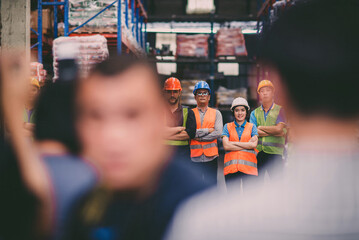 warehouse team hero standing protecting cargo. confident employee wear safety vest and helmet ready to defense storage stock for client at any cost. empower cooperate staff group protecting shipping