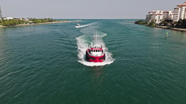 Boat tug at sea. Aerial footage of tow-boat transportation. Tugboat sailing at sea top view. Sea transport. Motor boat. Boating and tugging. Tugboat sea transportation