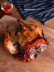 Whole Grilled Chicken on Wooden Table.