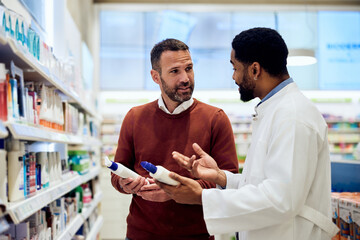 Man Discussing Products With Pharmacist in a Bright Pharmacy Aisle