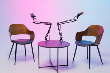 Setup for an engaging podcast interview with microphones and chairs arranged for conversation